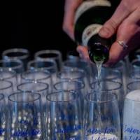 Champagne is poured into Lake for a Lifetime champagne flutes